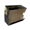 Boîte bûche noire avec motifs dorés ouverte.