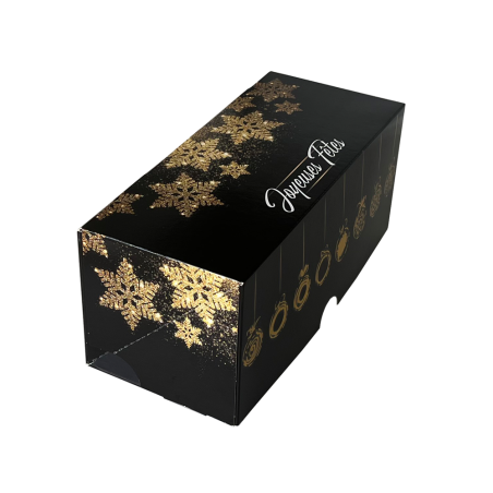 Boîte bûche noire avec motifs dorés vue de 3/4. Boîte bûche noire avec motifs dorés vue de 3/4.